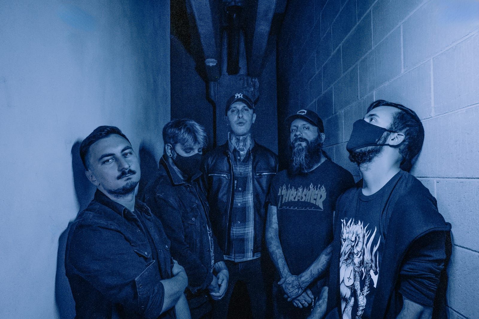 Astraline, the five members in a narrow corridor, in blue light